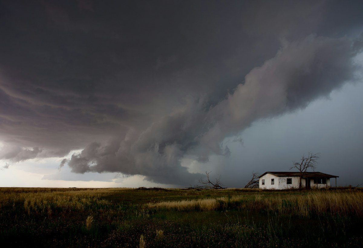 Dark storm clouds gathering over an open landscape